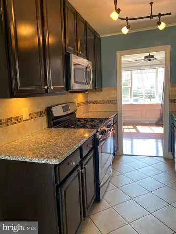 a kitchen with granite countertop a stove and a sink