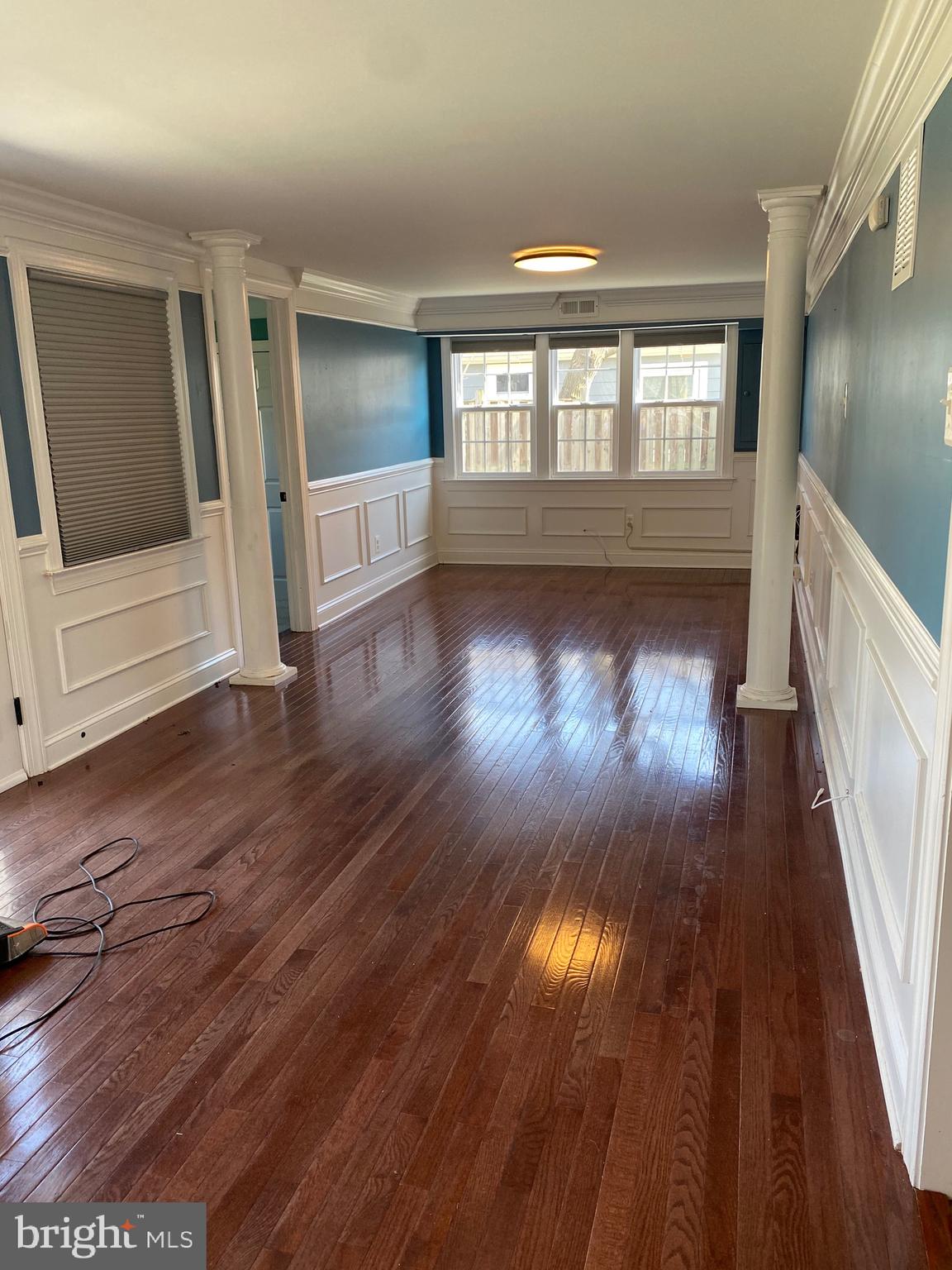 1403 Gleason Street Silver Spring, MD 20902 - Photo 22 of 34 an empty room with wooden floor and windows