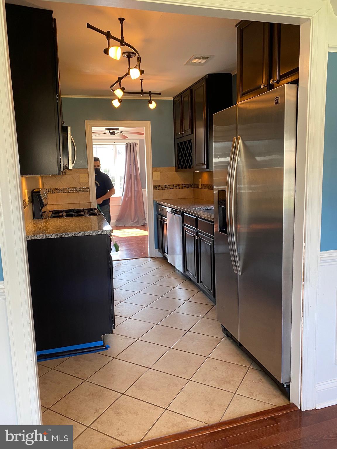 1403 Gleason Street Silver Spring, MD 20902 - Photo 26 of 34 a kitchen with stainless steel appliances granite countertop a refrigerator and a stove