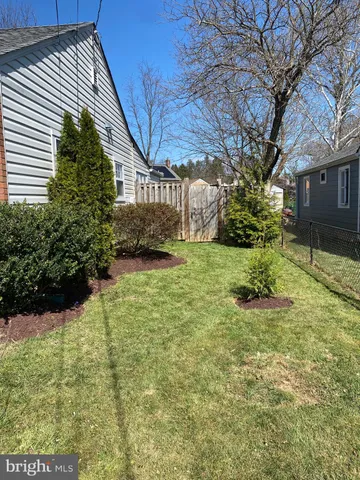 a view of a backyard with a white house
