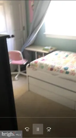 a view of a backyard with table and chairs with wooden fence and plants