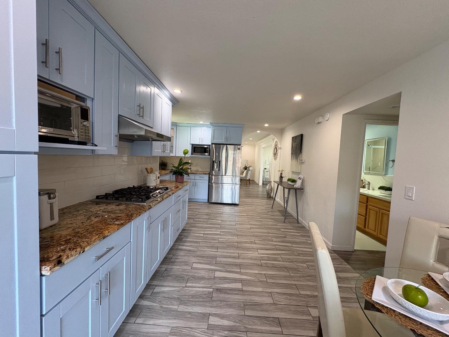 5187 Doyle Road San Jose, CA 95129 - Photo 16 of 39 a large kitchen with stainless steel appliances granite countertop a stove and a sink