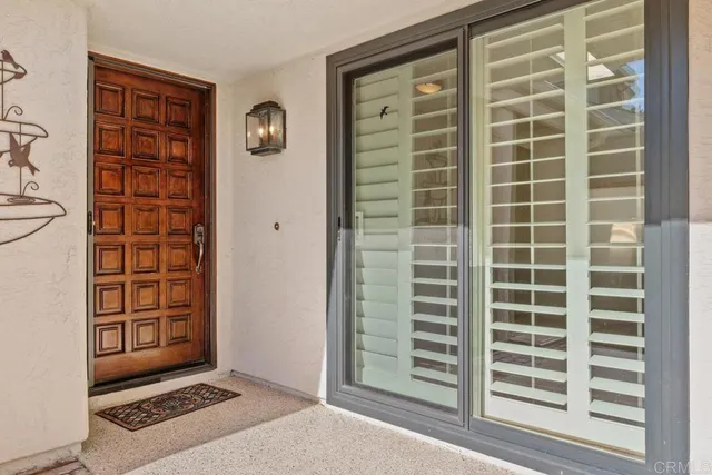 a view of an empty room with windows and wardrobe