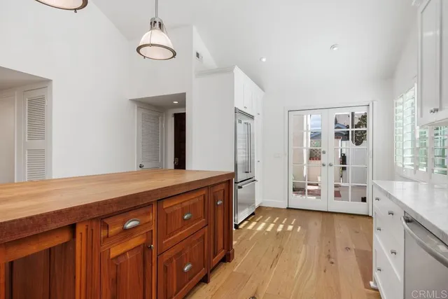 a spacious bathroom with a granite countertop sink a large mirror and a bathtub