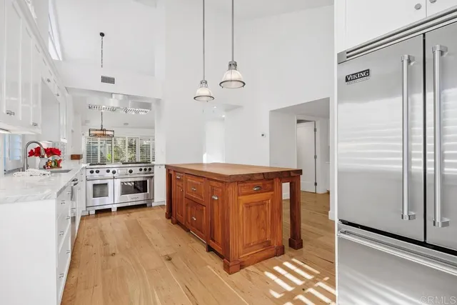 a kitchen with stainless steel appliances granite countertop a stove a refrigerator and a refrigerator