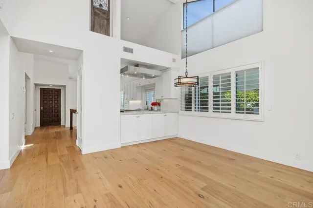 a view of a kitchen with wooden floor and a window
