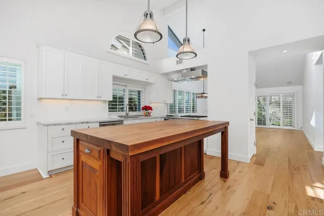 a kitchen with a stove and a chandelier