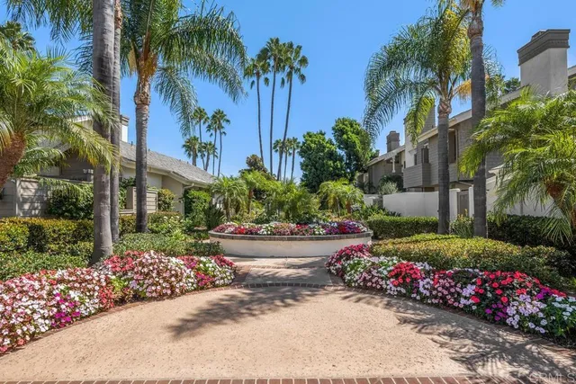 a garden with flowers and palm trees