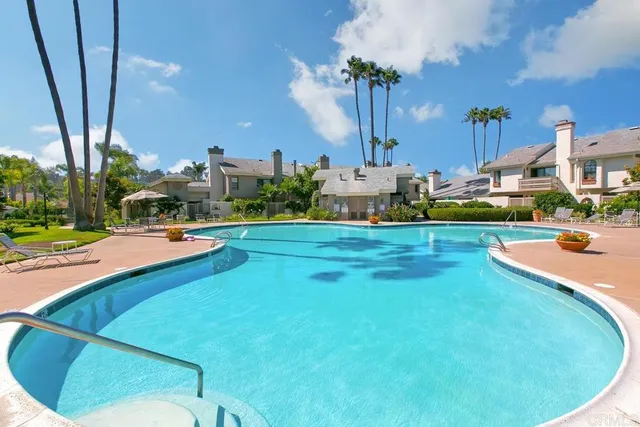 a swimming pool with outdoor seating and yard