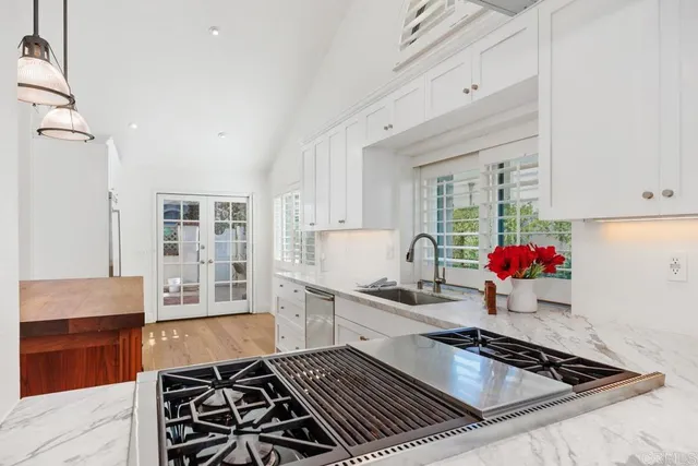 a kitchen with a sink and a stove top oven