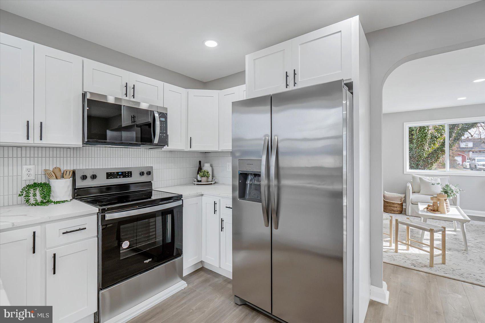 3526 Millvale Road Baltimore, MD 21244 - Photo 14 of 41 a kitchen with stainless steel appliances granite countertop a refrigerator stove and sink