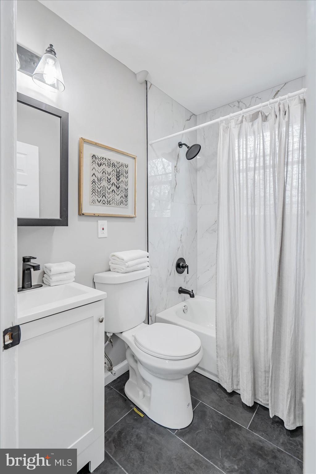 3526 Millvale Road Baltimore, MD 21244 - Photo 21 of 41 a white toilet sitting next to a bathroom sink