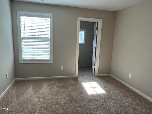 an empty room that has a window in it