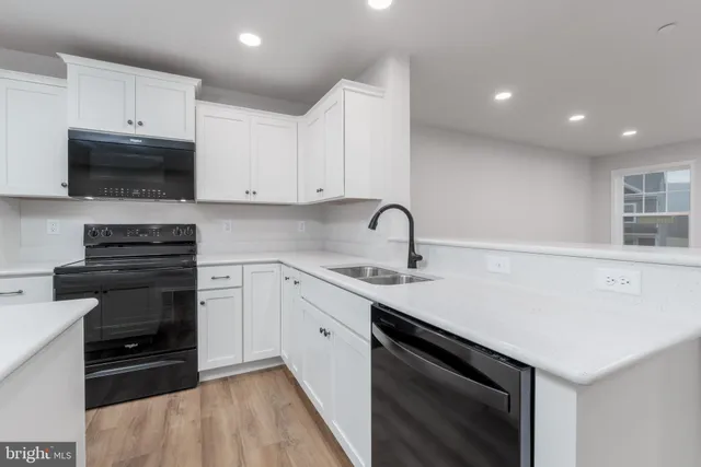 a kitchen with a sink stove and microwave