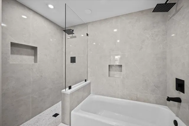 a bathroom with a bathtub and shower