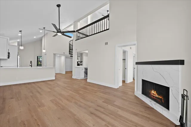 a view of empty room with wooden floor fireplace and window