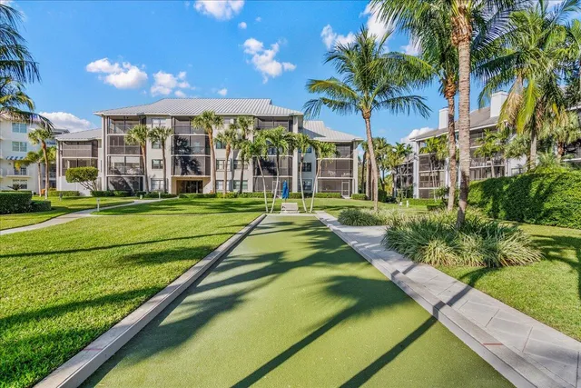 a view of a swimming pool with a garden and patio