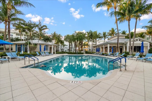 a view of a house with swimming pool and sitting area