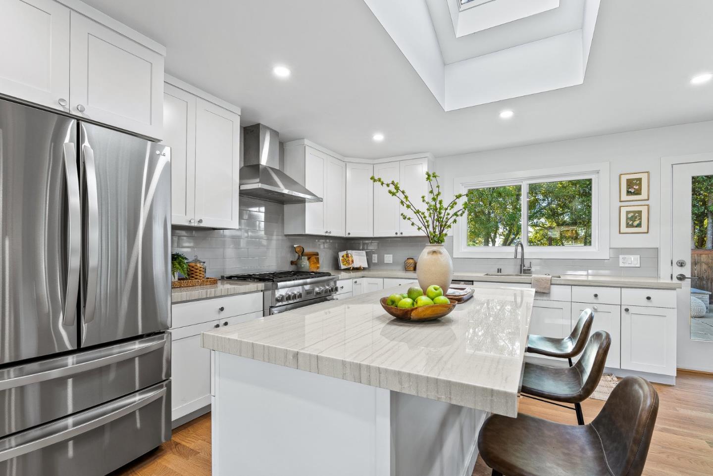 880 Pinehurst Drive Aptos, CA 95003 - Photo 12 of 25 a kitchen with stainless steel appliances a refrigerator a sink a stove and white cabinets
