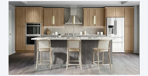 a kitchen with stainless steel appliances granite countertop a stove two chairs and a refrigerator