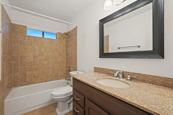 an empty room with a window and a ceiling fan