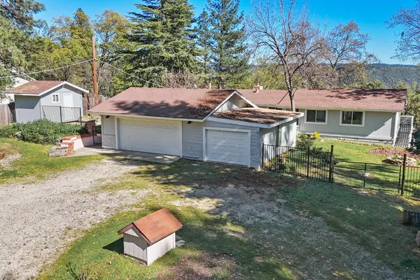 a front view of a house with a yard garage and outdoor seating