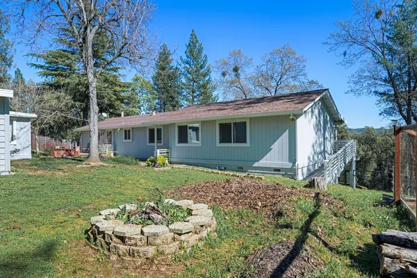 a view of a house with a yard and garden