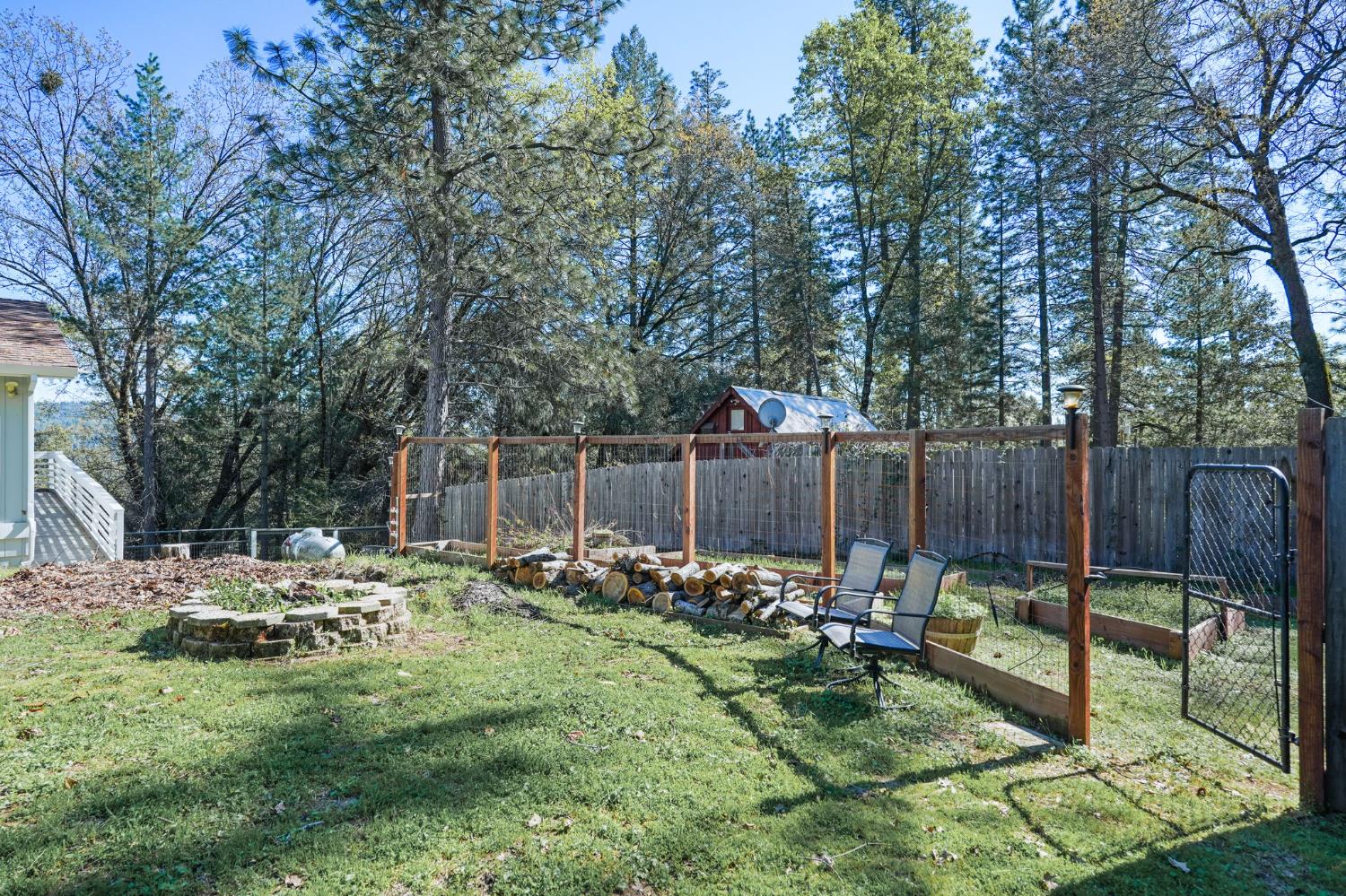 24980 North Canyon Way Colfax, CA 95713 - Photo 6 of 30 a view of backyard with wooden fence and trees