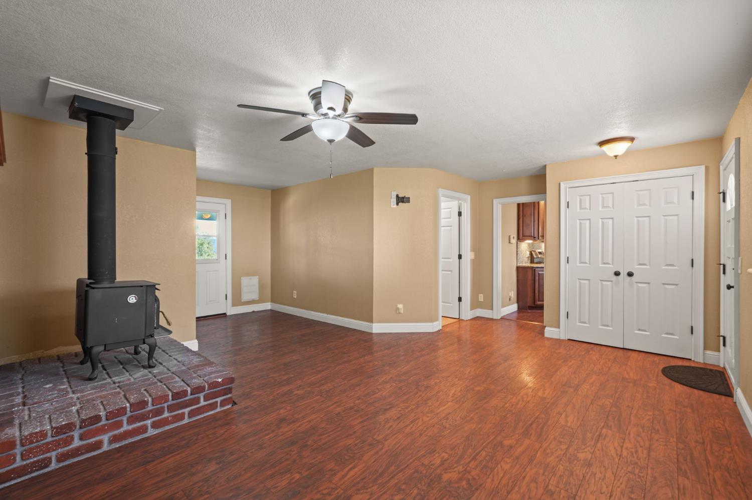 24980 North Canyon Way Colfax, CA 95713 - Photo 9 of 30 a view of an empty room with wooden floor and a ceiling fan