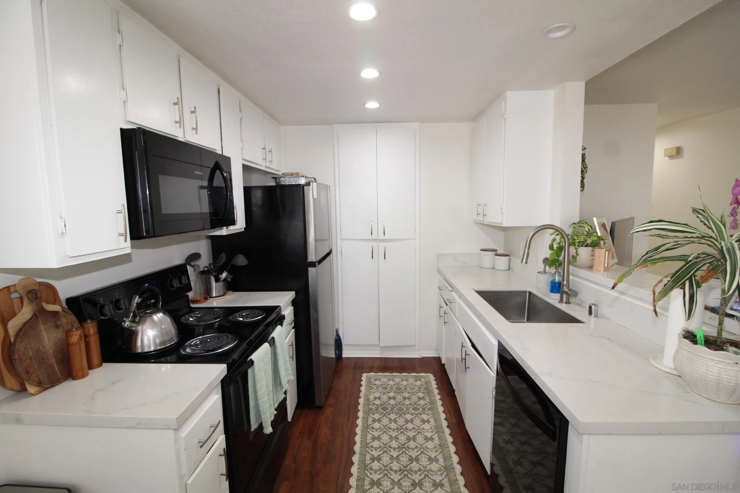 783 Timber Cove Way Oceanside, CA 92058 - Photo 11 of 28 a kitchen with a sink stove and refrigerator