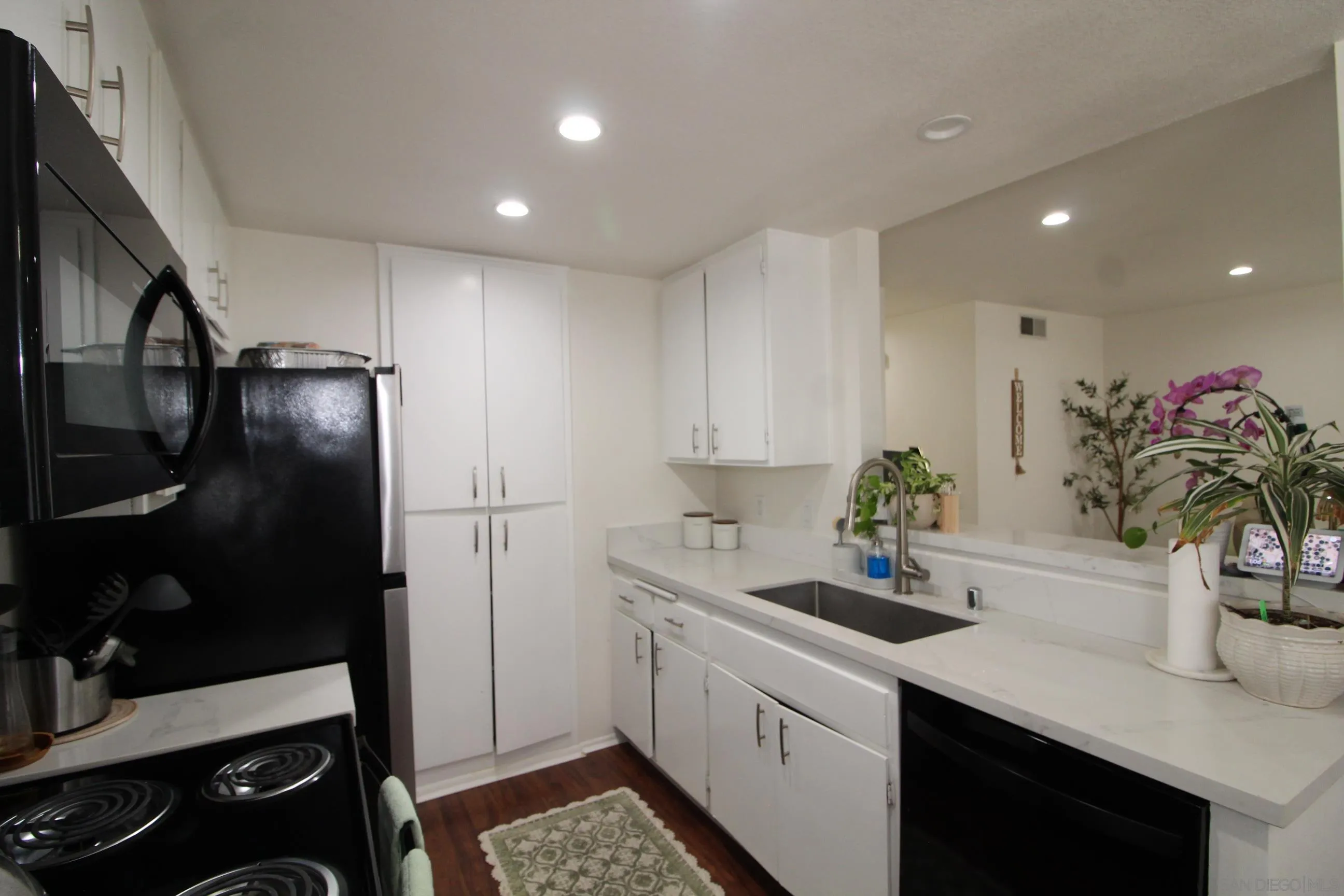 783 Timber Cove Way Oceanside, CA 92058 - Photo 12 of 28 a kitchen with a sink and cabinets