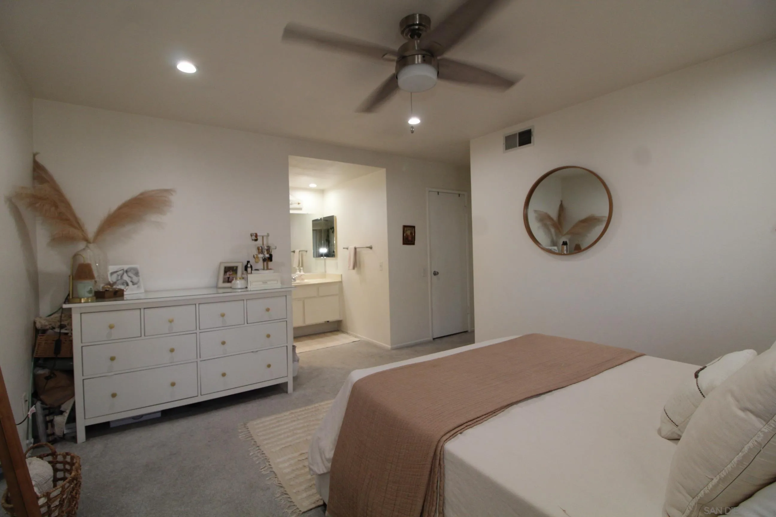 783 Timber Cove Way Oceanside, CA 92058 - Photo 14 of 28 a bedroom with a bed and a chandelier