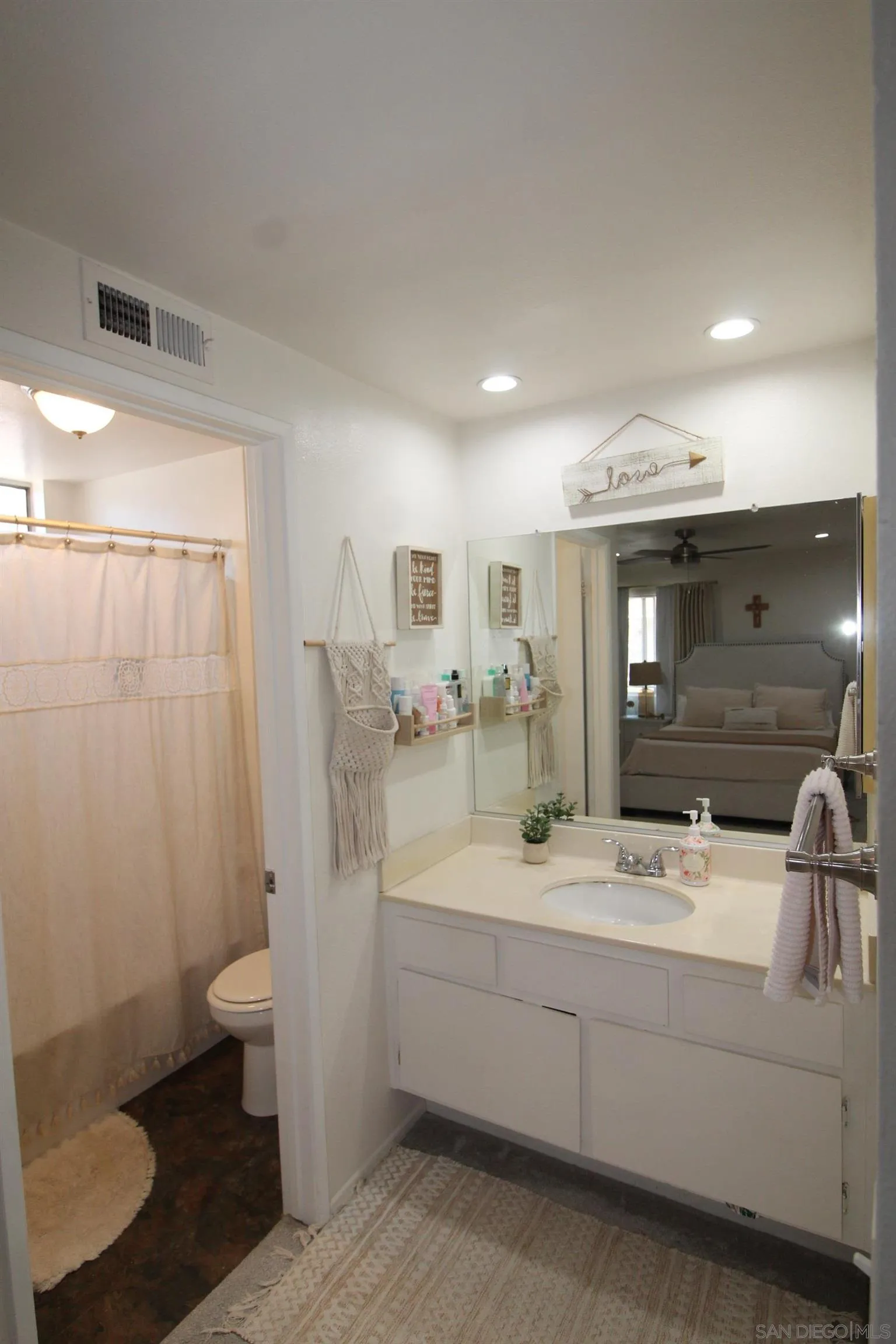 783 Timber Cove Way Oceanside, CA 92058 - Photo 16 of 28 a bathroom with a double vanity sink toilet and shower