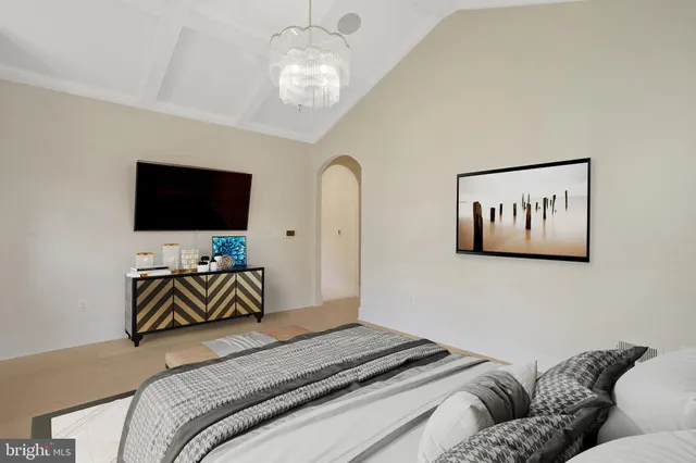 a bedroom with a bed and painting on the wall