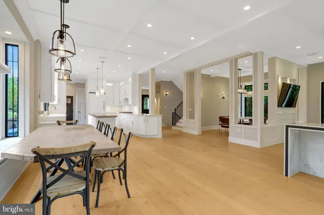 a large white kitchen with granite countertop a large window and white appliances