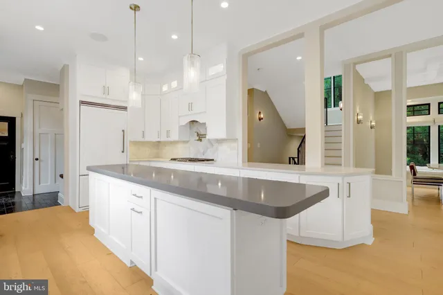 a dining room with furniture water view and a floor to ceiling window