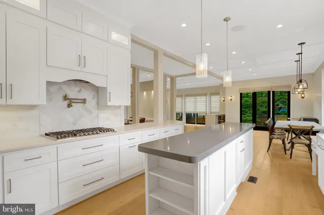 a large bedroom with a large bed and large windows