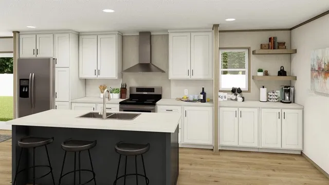 a kitchen with stainless steel appliances a sink a stove a refrigerator and cabinets