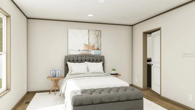 a bedroom with a bed and a window