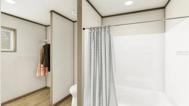 a bathroom with a shower and a glass door