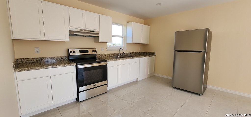 118 Grass Valley Road, Unit 208 Eagle Pass, TX 78852 - Photo 14 of 28 a kitchen with granite countertop white cabinets and white appliances