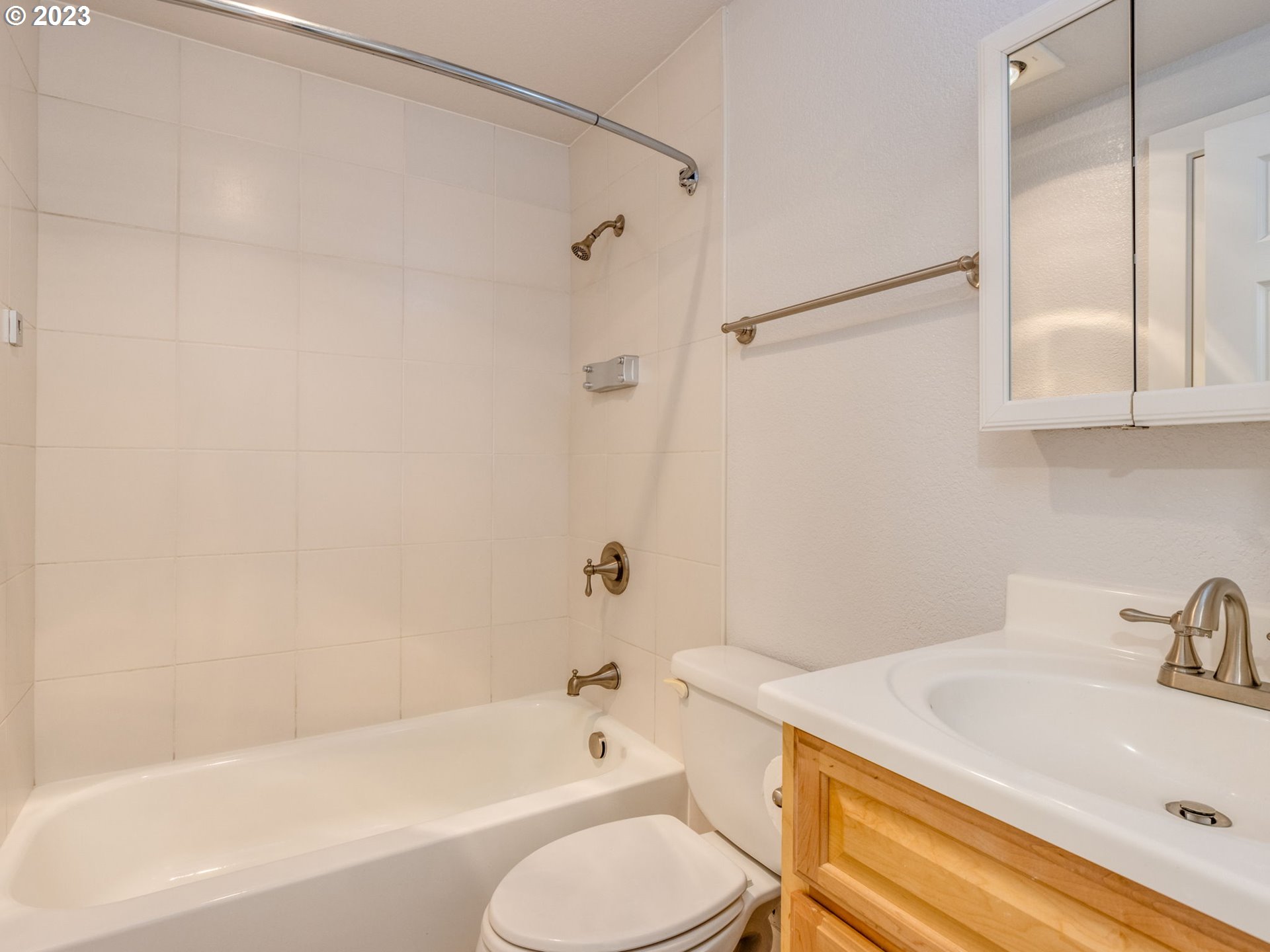 7937 Southwest 40th Avenue, Unit F Portland, OR 97219 - Photo 11 of 36 a bathroom with a sink toilet and shower