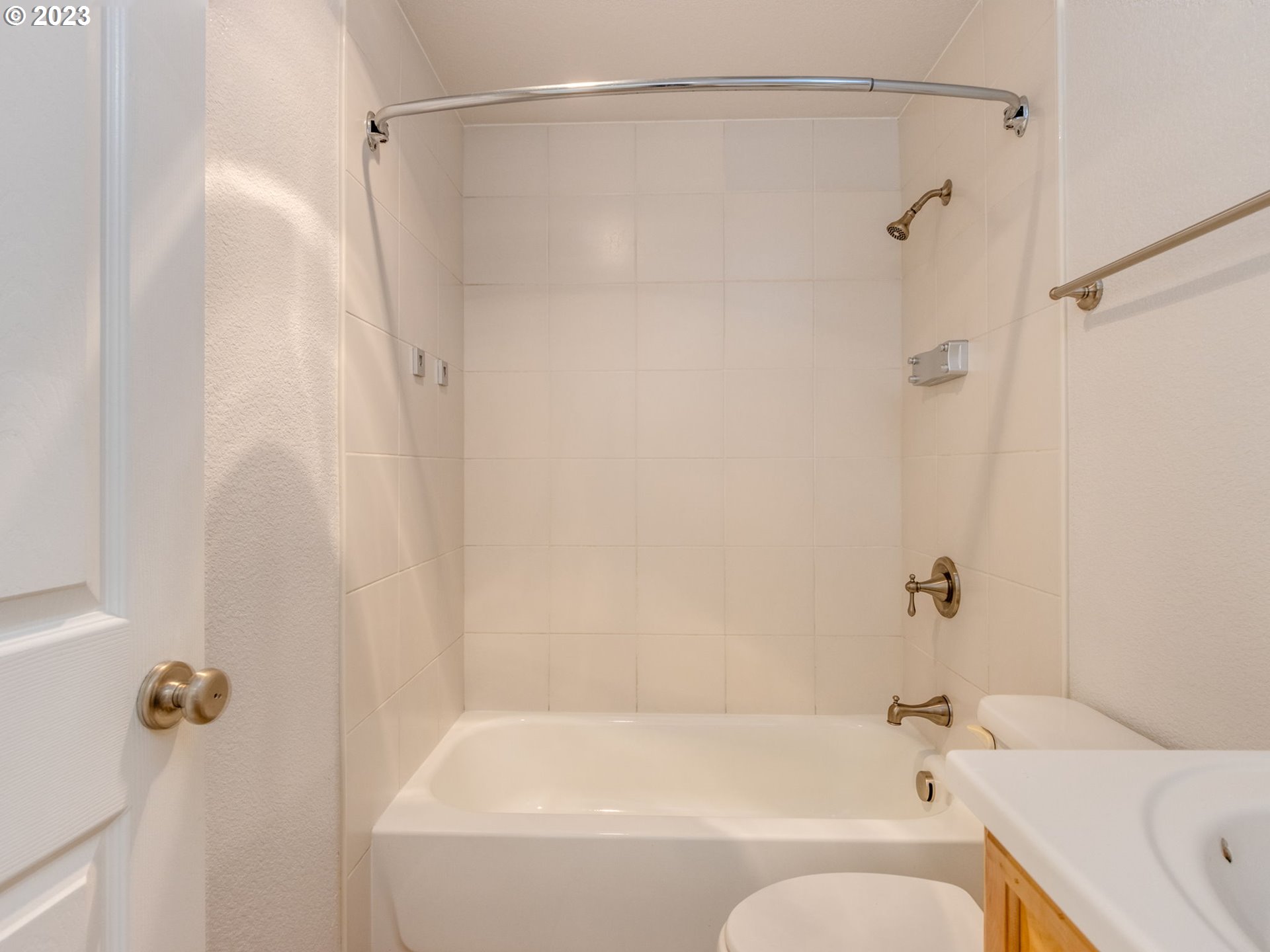 7937 Southwest 40th Avenue, Unit F Portland, OR 97219 - Photo 12 of 36 a bathroom with a shower and a bath tub