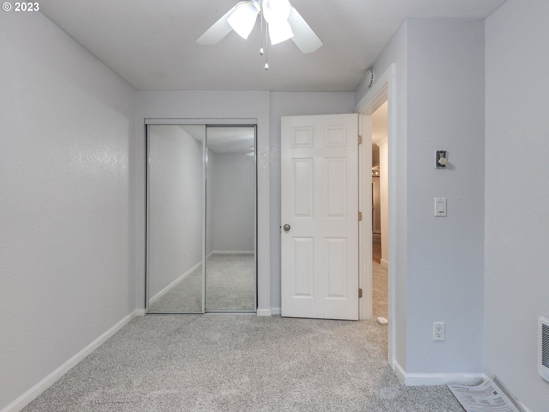 7937 Southwest 40th Avenue, Unit F Portland, OR 97219 - Photo 15 of 36 an empty room with fan in hallway