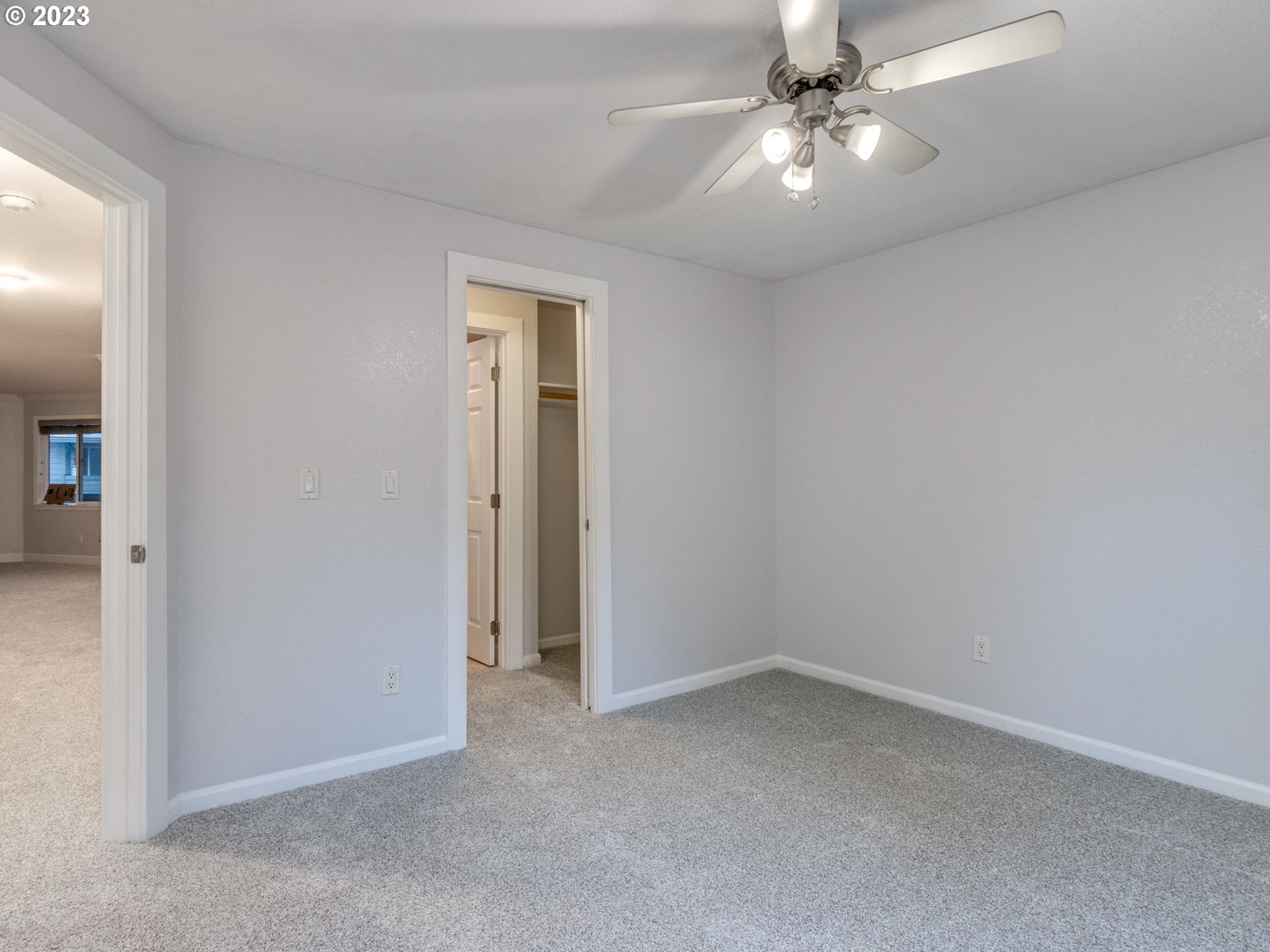 7937 Southwest 40th Avenue, Unit F Portland, OR 97219 - Photo 16 of 36 an empty room with a ceiling fan and a fan