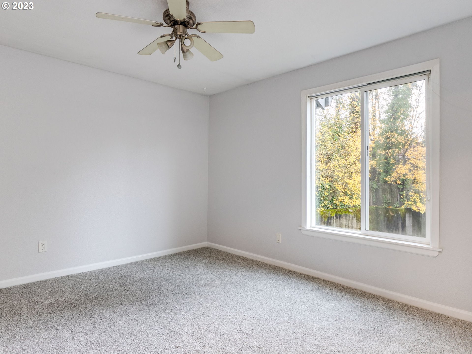 7937 Southwest 40th Avenue, Unit F Portland, OR 97219 - Photo 17 of 36 a view of a livingroom with a window and a chandelier fan