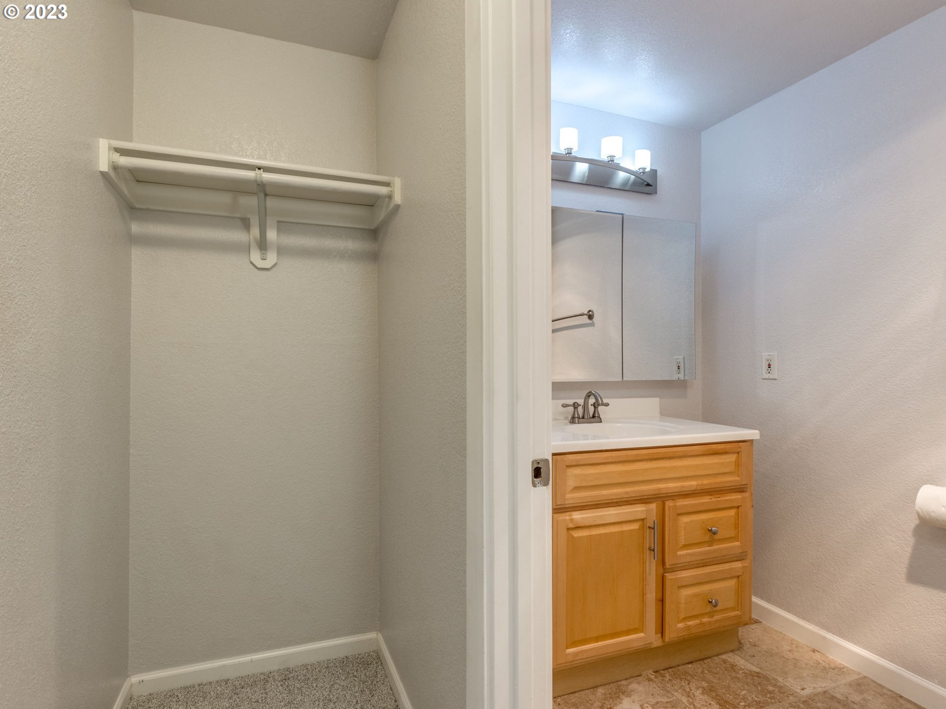 7937 Southwest 40th Avenue, Unit F Portland, OR 97219 - Photo 19 of 36 a bathroom with a sink a mirror and vanity