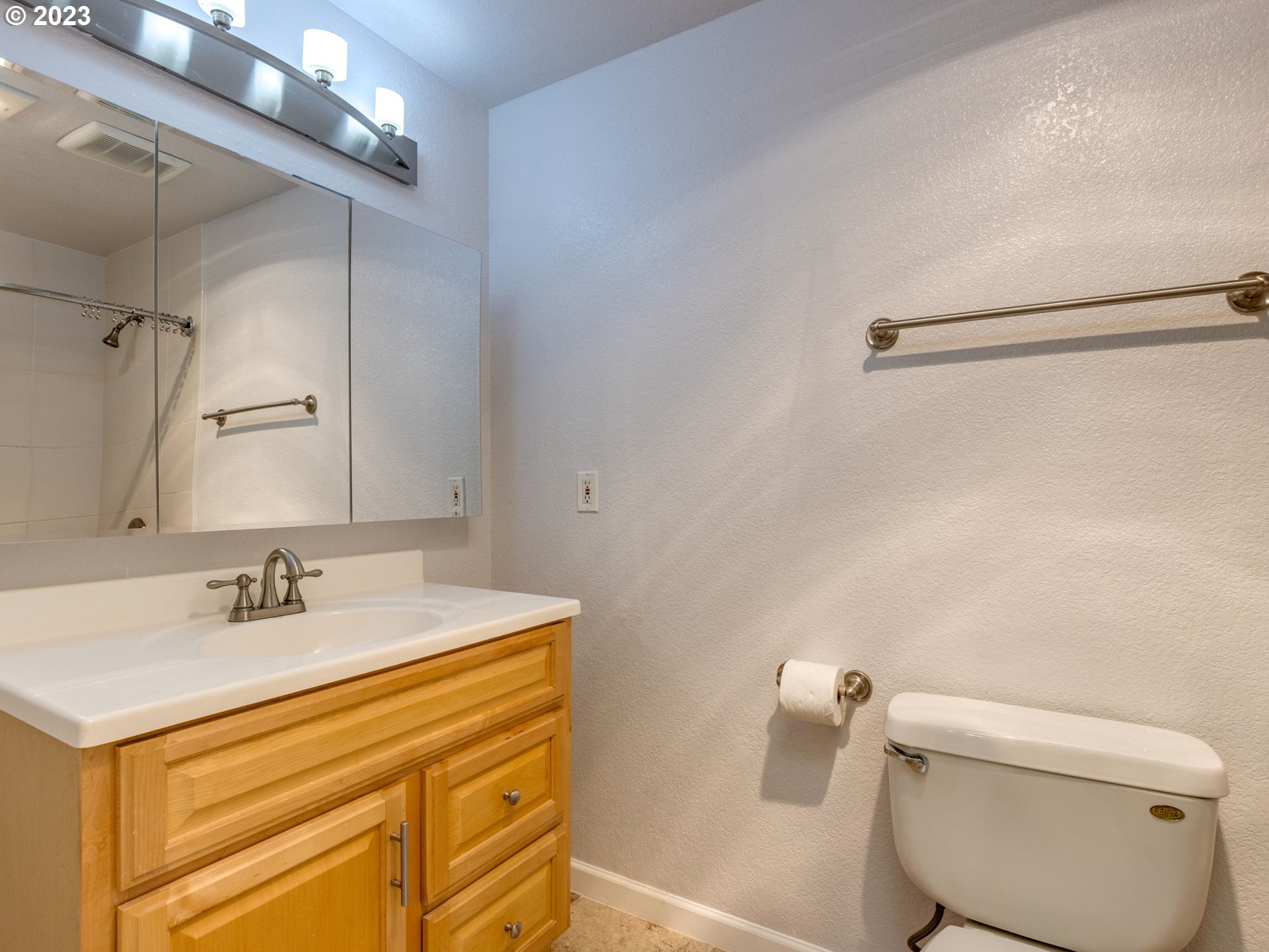 7937 Southwest 40th Avenue, Unit F Portland, OR 97219 - Photo 20 of 36 a bathroom with a sink and a mirror