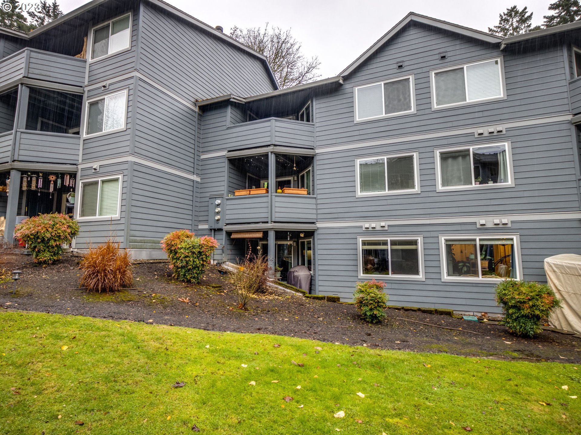 7937 Southwest 40th Avenue, Unit F Portland, OR 97219 - Photo 26 of 36 a view of a house with a yard and sitting area