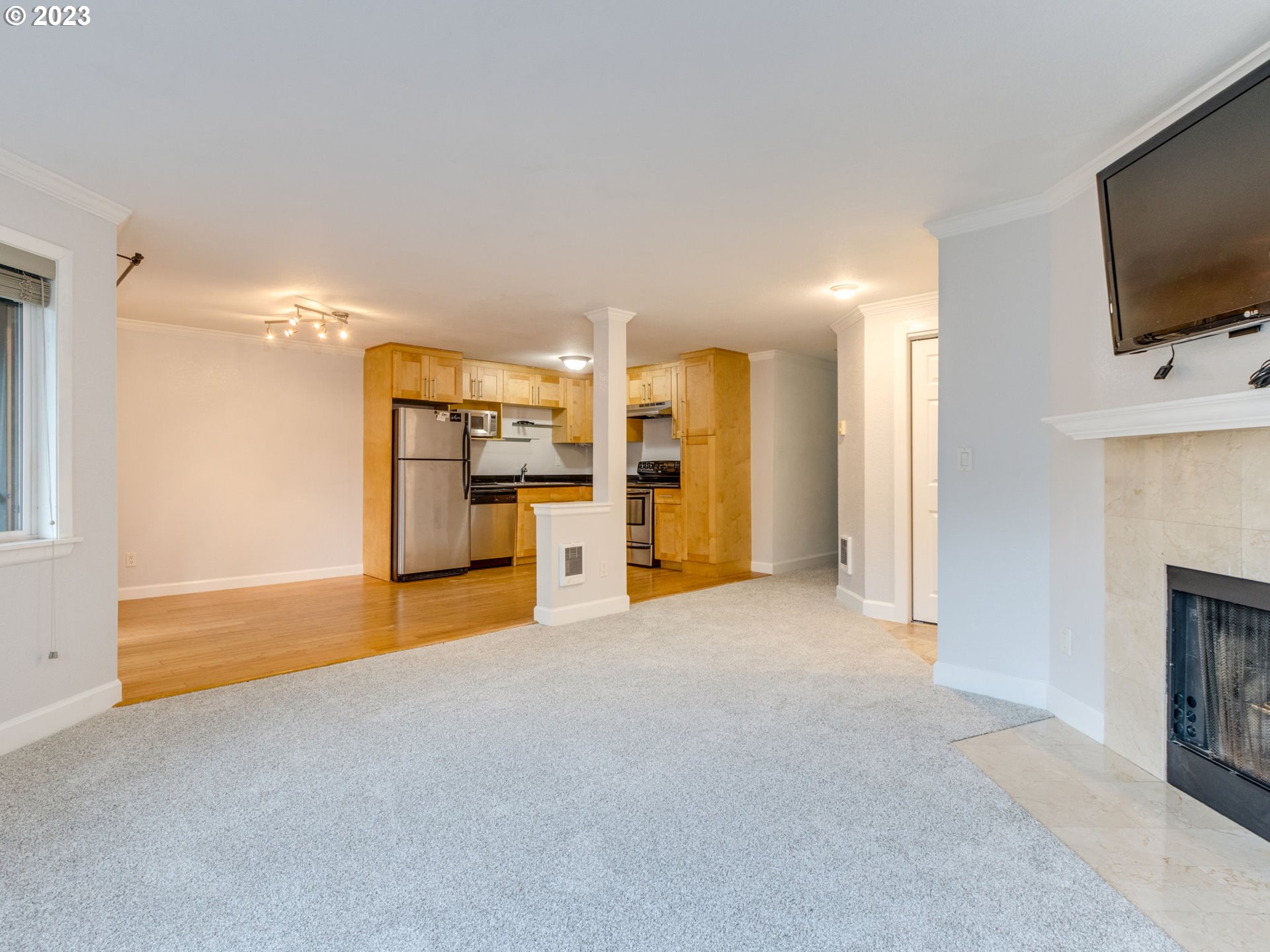 7937 Southwest 40th Avenue, Unit F Portland, OR 97219 - Photo 7 of 36 a view of a livingroom with furniture and a flat screen tv